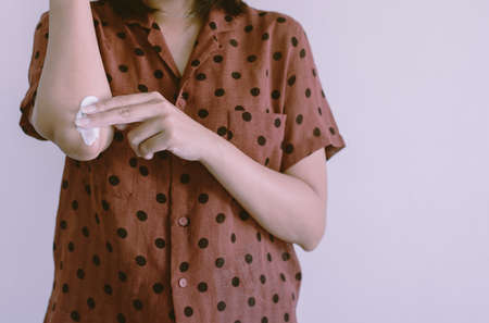Woman applying cream or lotion on dry elbow,Healthy skin body care concept,Close up