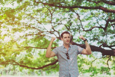 Successful man hands raise up and standing at nature,Happy and smiling,Positive thinking