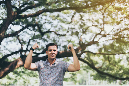 Successful man hands raise up and standing at nature,Happy and smiling,Positive thinkingの写真素材