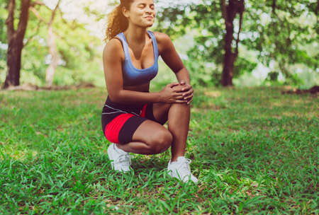 Sporty black woman suffering on her knee,Athlete female having pain in the knee