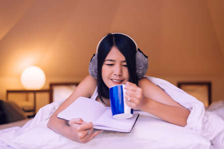 Happy asian woman holding and drinking hot coffee in the morning, Enjoys of resting time, Close up