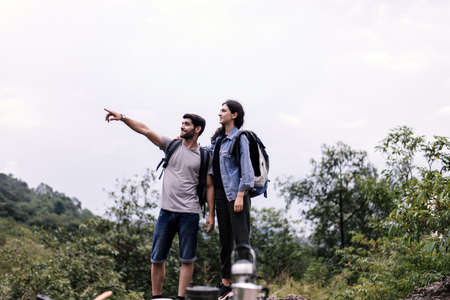 Couple lover standing with hands pointing something and looking beautiful view together, Happy and...