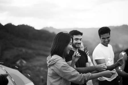 Group of diversity friends with sparklers and enjoying together at outdoor, Happy new year concept, Black and white tonedの写真素材