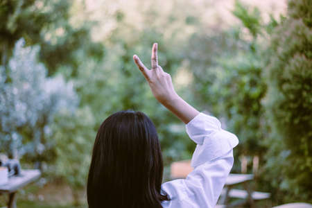 Woman showing two fingers in tent after wake up in the morning,Positive thinking,Relaxing time,Back...