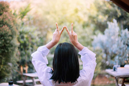 Woman showing two fingers in tent after wake up in the morning, Positive thinking, Relaxing time,...