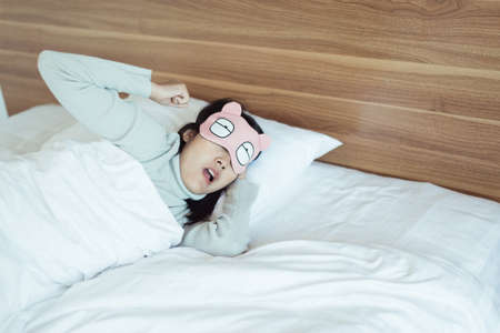 Woman yawning on her bedroom and tired sleepy,Symptoms and sleepiness