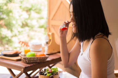 Excretory good system concept,Woman hands holding and eating healthy salad for breakfast in the morningの写真素材