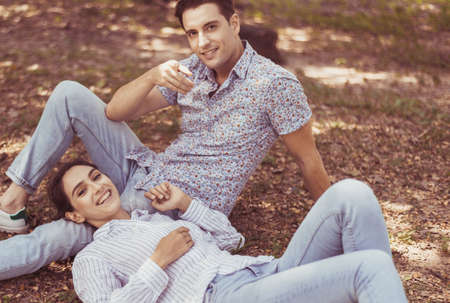 Couple young lover lying down on green grass in park together,Romantic and enjoying in moment of...