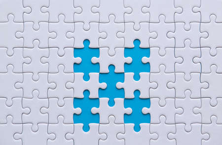 Jigsaw puzzle white color,Puzzles pieces grid,Success mosaic solution template,Horizontal on blue color background copy space for text,Top viewの写真素材