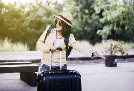 Beautiful asian woman tourist waiting train at train station,Travel and vacation conceptの写真素材
