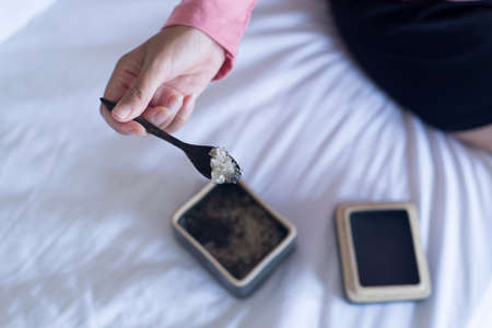 Hands woman holding himalayan salt in wooden spoon at hotel,Beauty and skincare conceptの写真素材