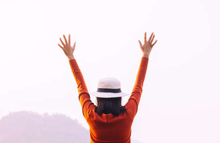 Happy woman raise up hands at nature during sunset,Positive thinking,Free time,Back view