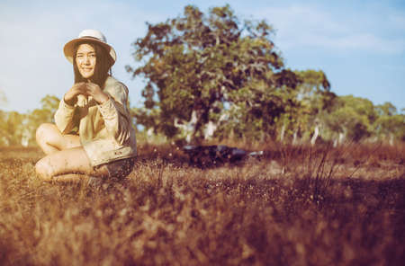 Beautiful asian woman showing hands heart shape at forest during sunset time,Happy and...