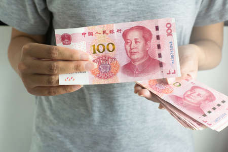 Hand women counting 100 china yuan banknote,Close upの写真素材