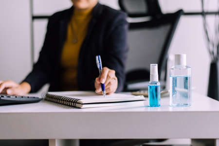 Sanitizer gel in spray bottle and hand sanitizer gel for coronavirus protection,Working at home,Work from home conceptの写真素材