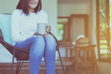 Happy asian woman drinking hot coffee in bedroom at home,Coffee break,Take a break,Relax timeの写真素材
