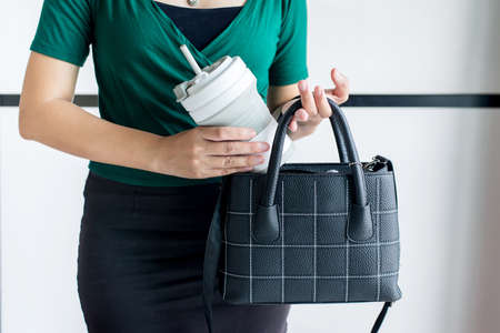 Hand woman holding reusable a drink water cup,Healthy green,Zero waste,Environmental friendly,Conscious lifestyle conceptの写真素材