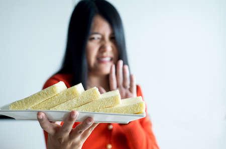Woman hands refusing white bread,Female having allergy to bread,Food intolerance defined concept