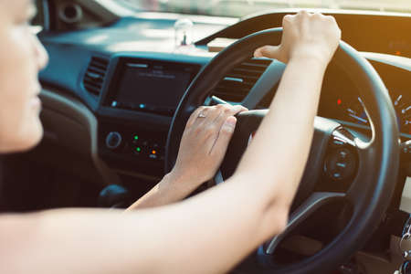 Hands woman holding steering wheel,Driving a car on road