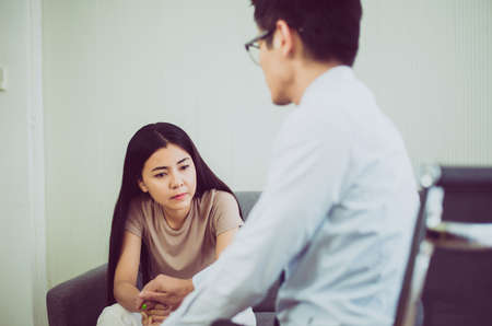 Professional psychologist talking with asian woman patient,Therapist conducting a consultation and...