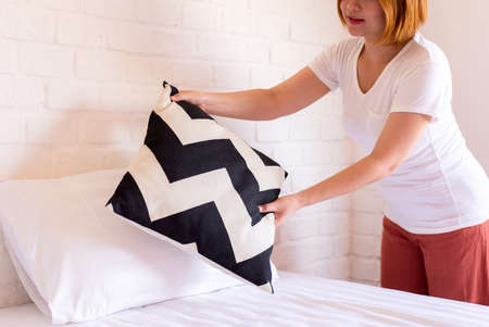 Make a bed,Woman hands making her bed in room after wake up in the morningの写真素材