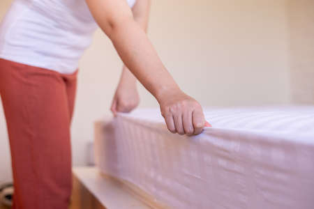Make a bed,Woman hands making her bed in room after wake up in the morningの写真素材