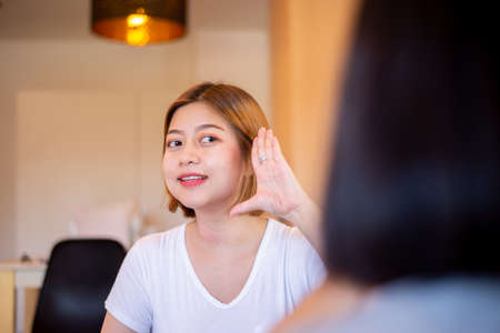 Asian woman patient deaf hearing talking with specialist sign language and showing hands gestureの写真素材