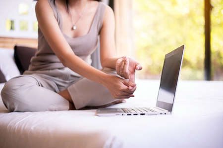 Woman suffering from beriberi on finger,Numbing pain in handの写真素材