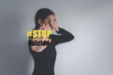 Against woman hands open wtih word stop suicide on white background,Suicide prevention concept