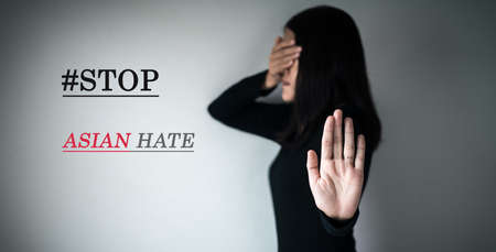 Woman showing hand stop with text stop asian hate,Racism against asian people campaign,Stop asian hate conceptの写真素材