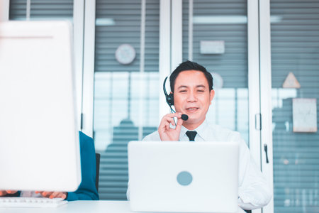Operator asian men working with headset at workplaceの写真素材
