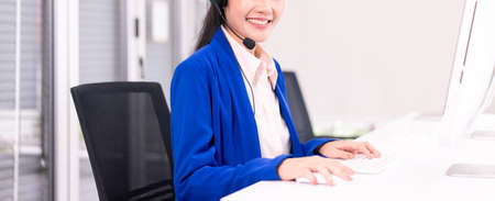 Unknow and close up,Operator women working with headset at workplace,Beautiful miling call center womanの写真素材