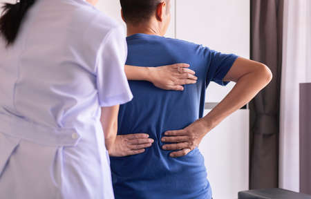 Physiotherapist woman doing treatment to man patient in clinic,Physical therapy conceptの写真素材