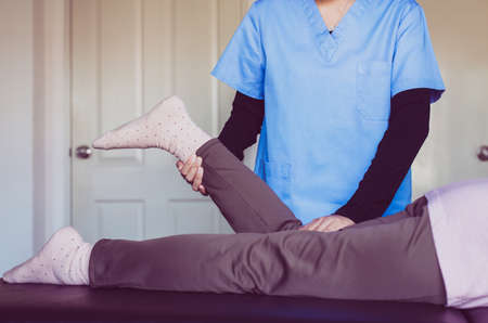 Physiotherapist doing treatment to senior woman patient in hospital ,Elderly women leg pain,Physical...
