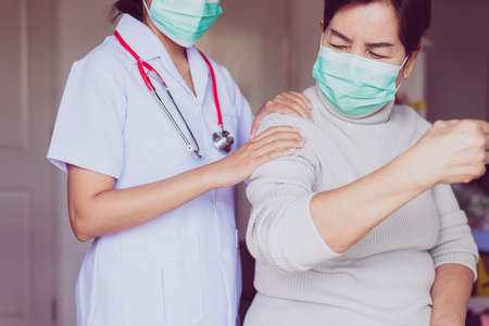 Physiotherapist doing treatment to senior woman patient in clinic,Elderly women suffering with...