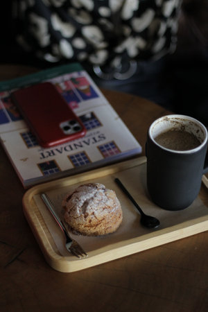 Photo of a laptop on a laptop or sofa. Photo of a girl's hand with a phone and coffee, there is a...