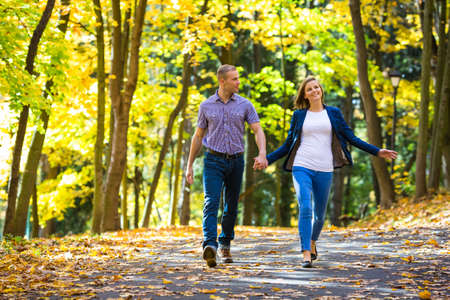 Urban leisure - woman and man walking in park Urban leisure - woman and man walking in park