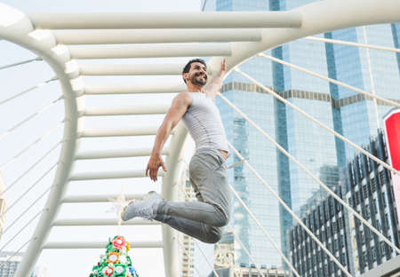 Young handsome sport man jumping training outdoors healthy lifestyle and sport concept.
