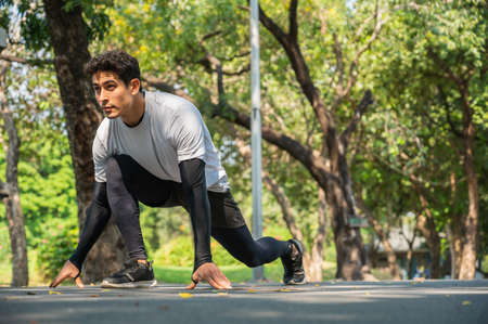 Young Athlete man in running start pose