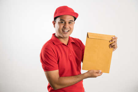 Red Delivery handsome asian man holding parcel cardboard box on isolated white background.