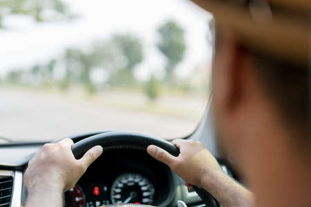 The hand is holding the steering wheel of the car Safe driving