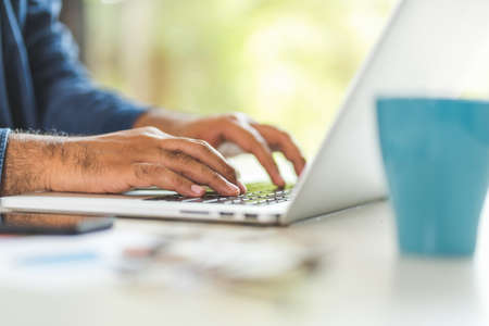 Close up male hands using laptop while work from home social distancing concept. Focusing Finger...