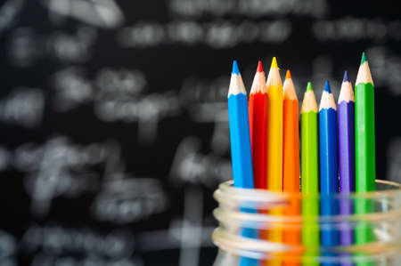 Education background concept. Color pencil in glass jar with blackboard.の写真素材