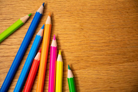 Education background concept. Color pencil on the wooden table.