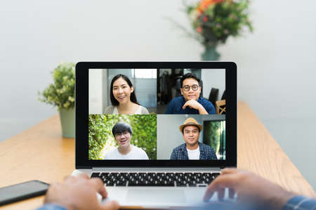 Asian business people video conference online on laptop. Meeting businessman and woman discussion corporate work from home.の写真素材