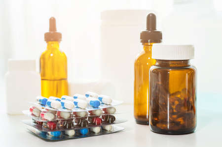 A lot of Colorful Medicine pills, tablets and capsules in packaging and bottle.の写真素材