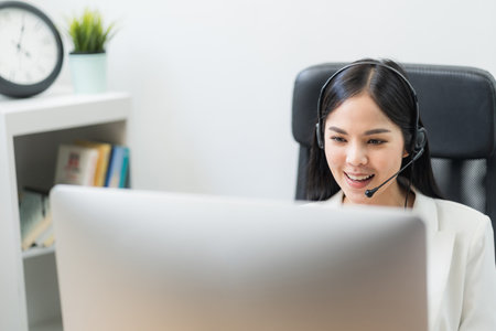 Young business asian woman working call centre customer service agents. Business female support...