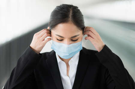 Business woman wearing protection mask. Beautiful female protective virus and pollution with face mask.の写真素材