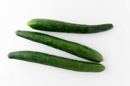 Pile Cucumber sliced into different ways ring and circle put on white table isolated background. Healthy vegetables and food.の写真素材
