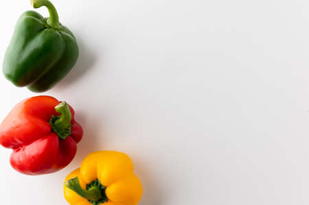 Raw red and yellow bell pepper on white table. Healthy vegetables and food.の写真素材